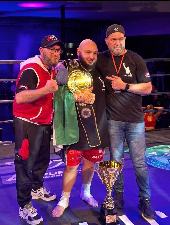Rogers Gym fighter with championship belt and trophy