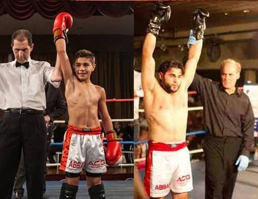 Young fighters with hands raised in victory