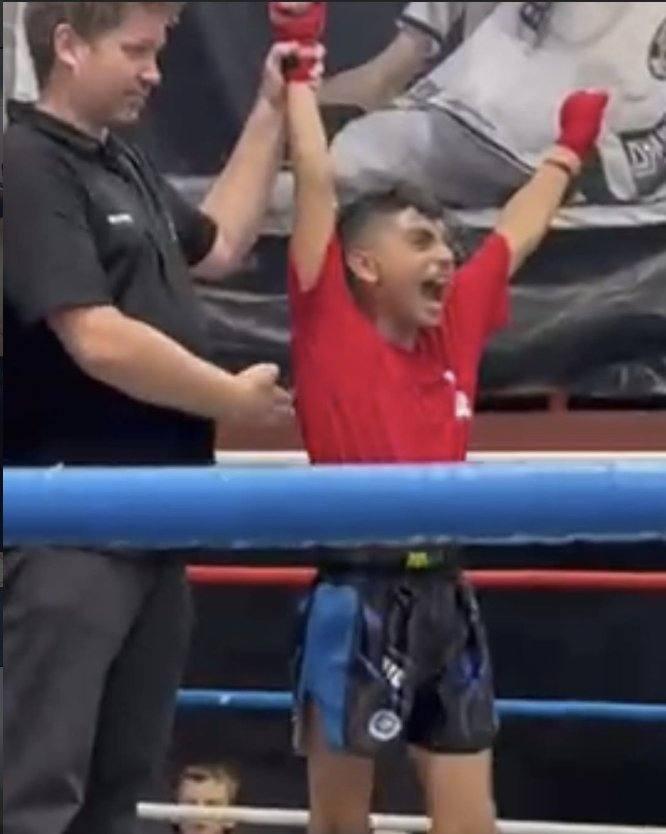 Young boxer getting his hand raised