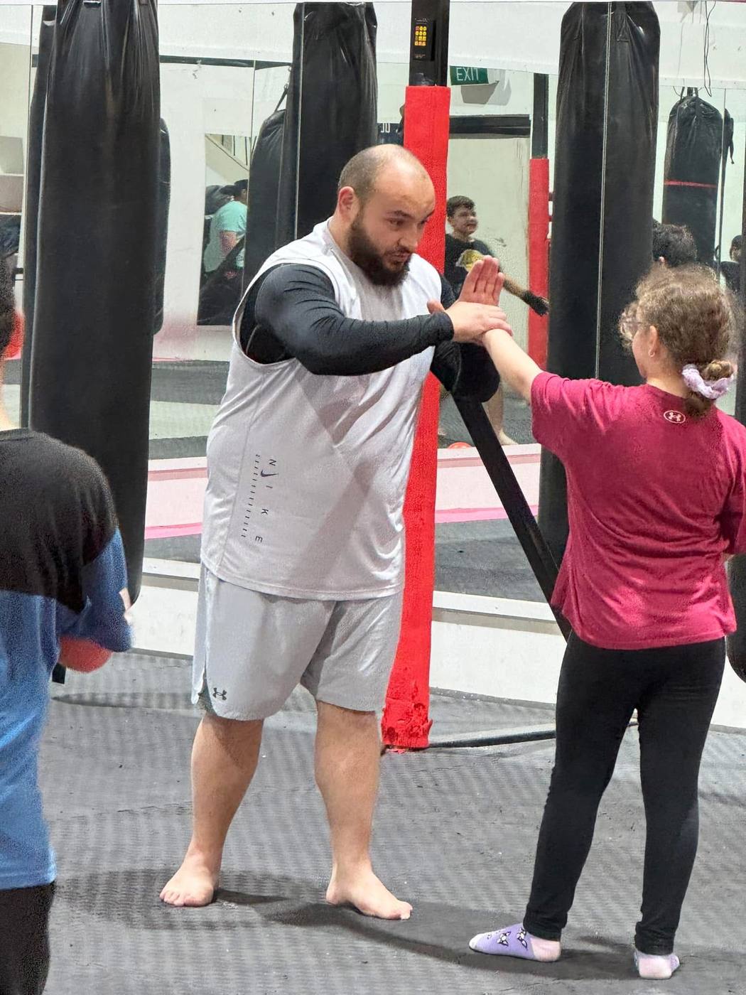 Coach taking a member through pad work