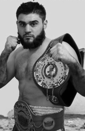 Roger Abbas with his championship belts